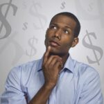 An image showing a man thinking about money