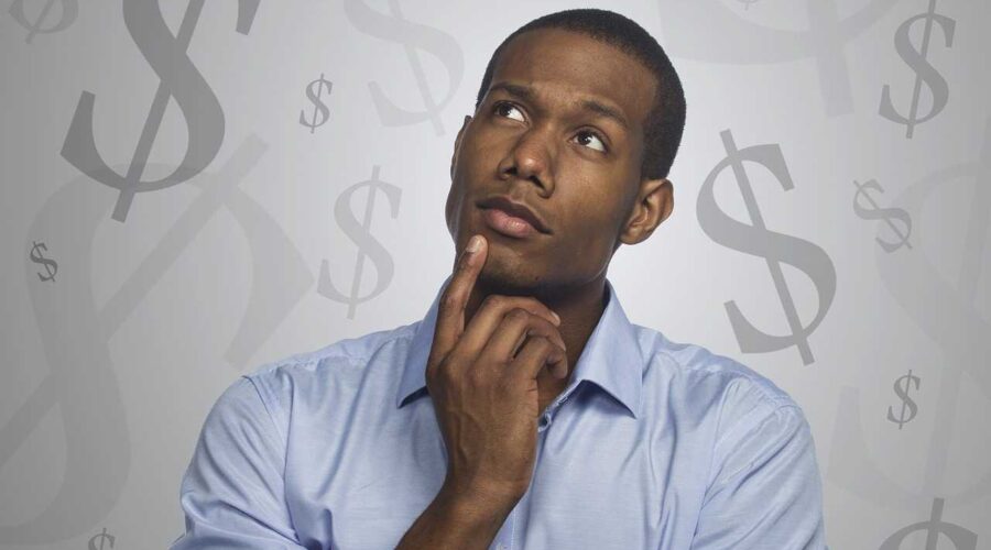 An image showing a man thinking about money