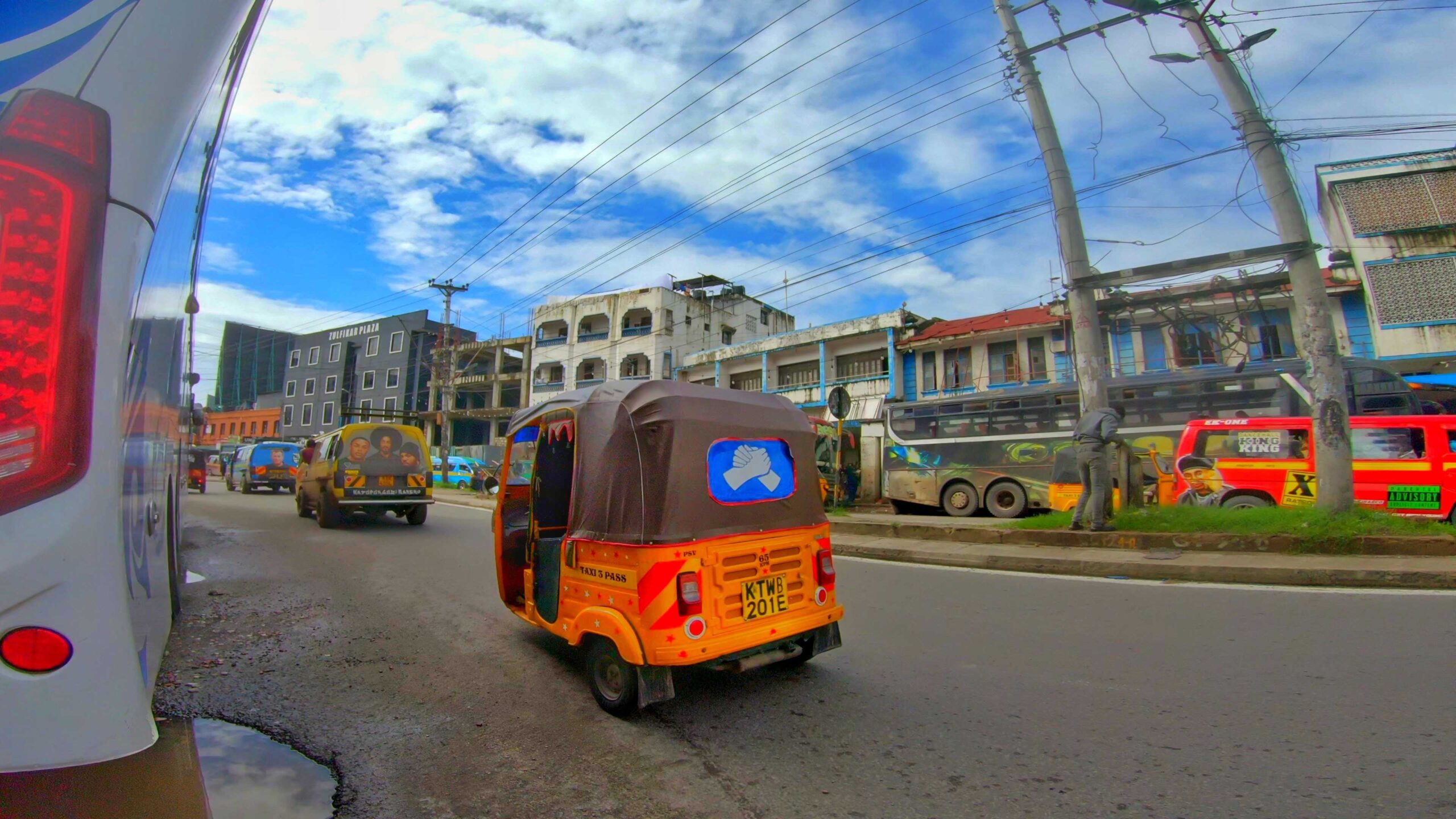 A yellow tuk on the road