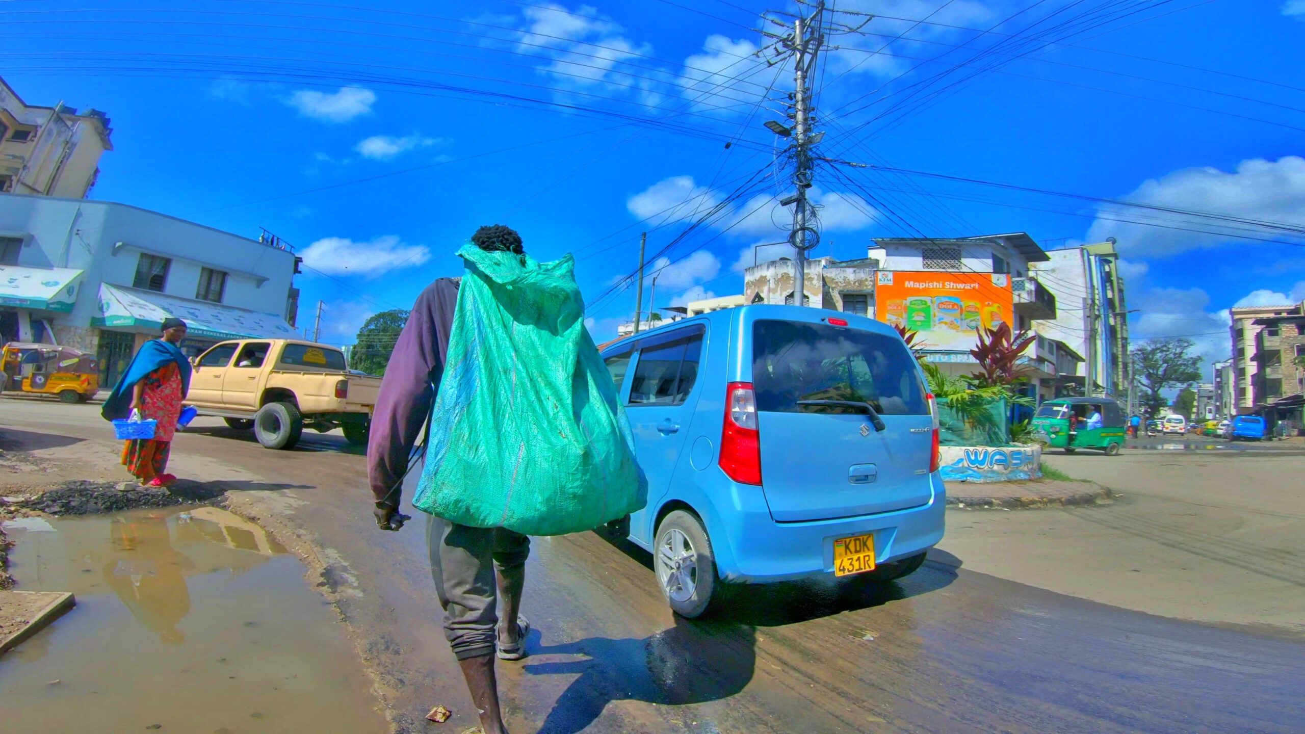 An image showing a street guy with a sack walking 