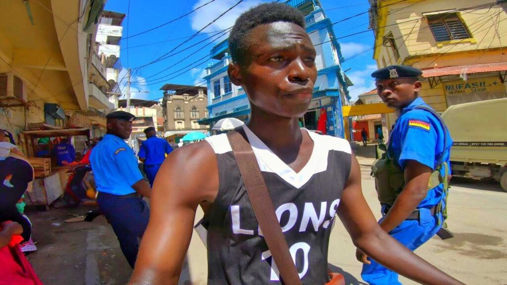 Walking past two police men while filming in Mombasa old town 