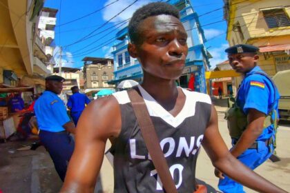 Walking past two police men while filming in Mombasa old town