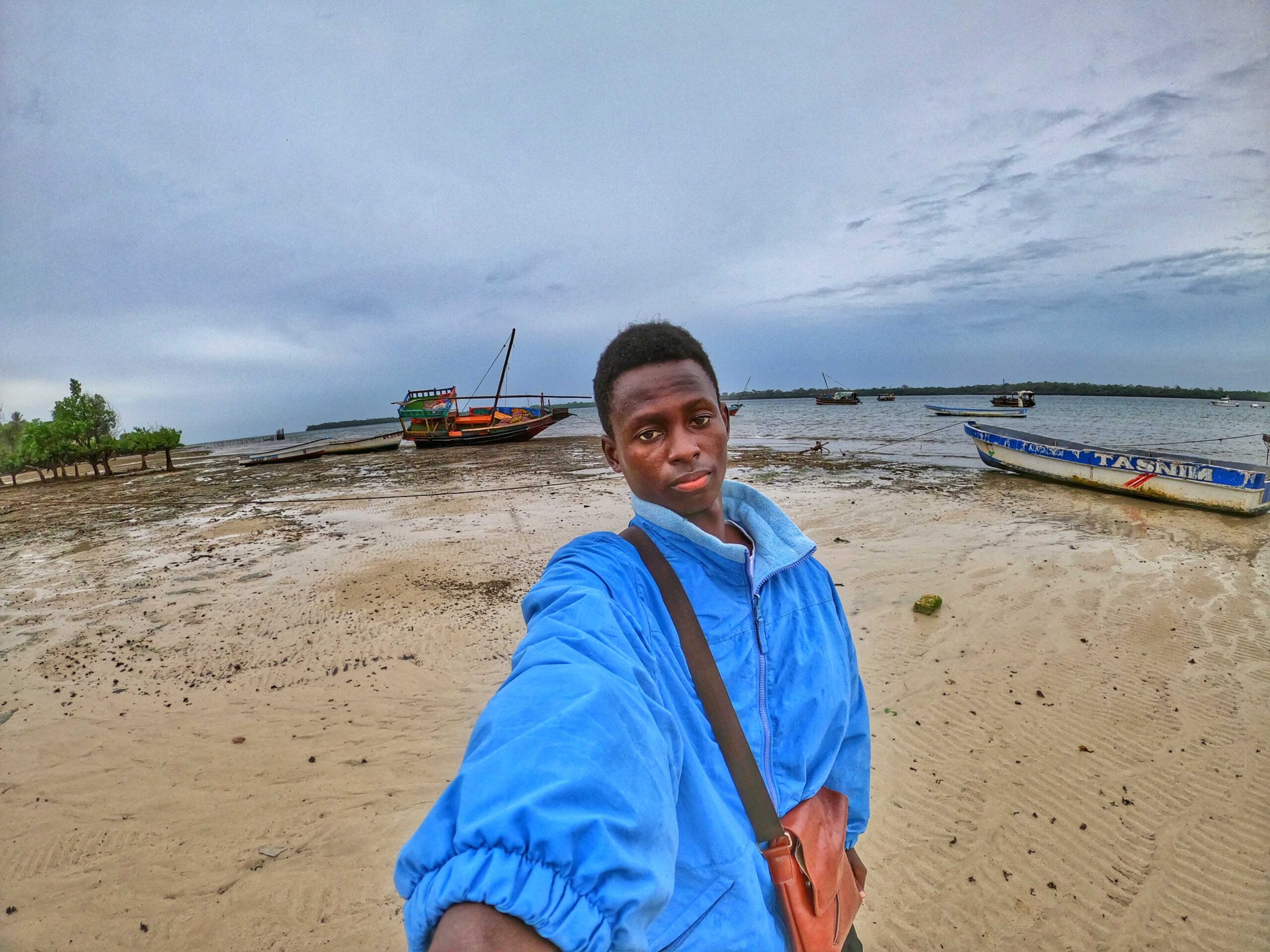 An image of me carrying a small side way bag on a beach