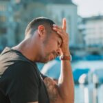 A man thinking hard about what to do after his girlfriend told him that she wanted to travel alone