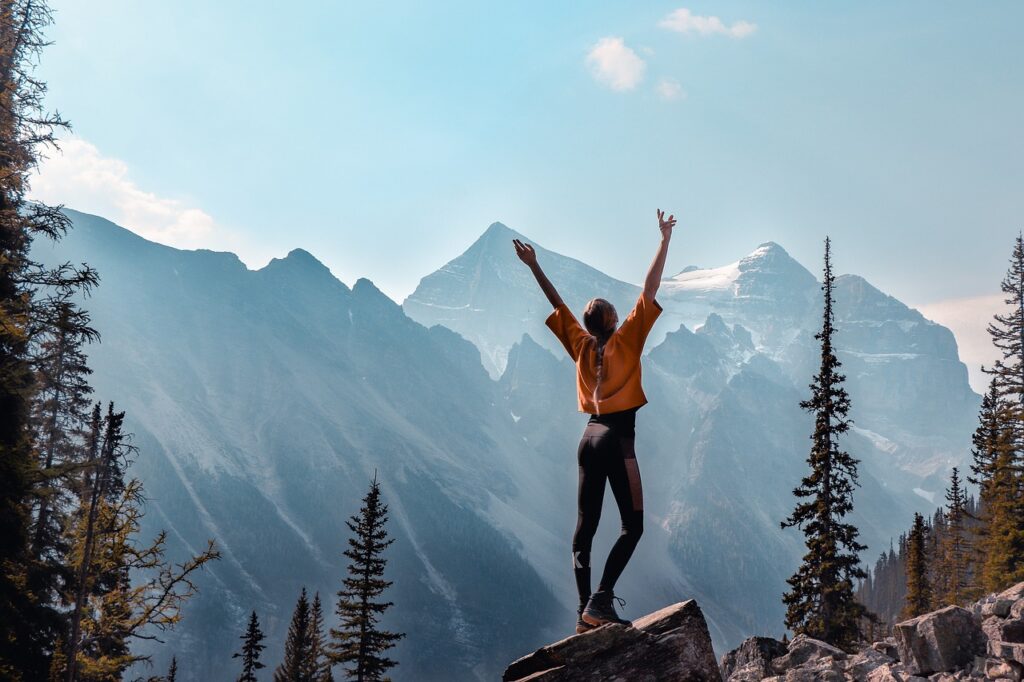 A girl standing on top of a cliff