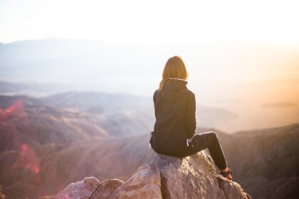 A Woman sitting on top of a hill