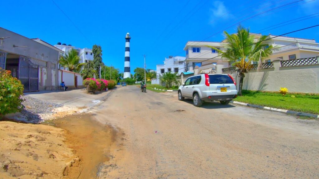 The view of lighthouse and buildings and car in Kizingo