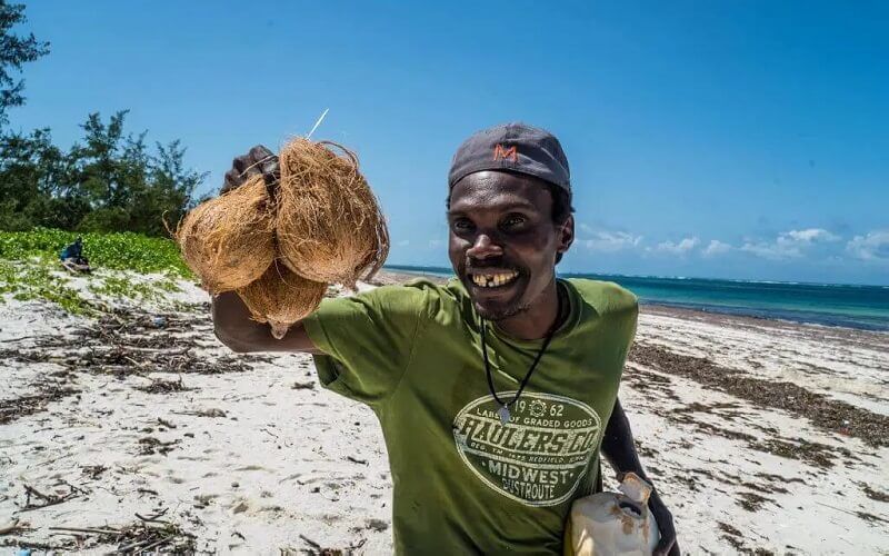 A vendor selling coconuts at Watamu Beach