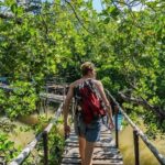 A man walking on a boardwalk in Watamu at Mida Creek