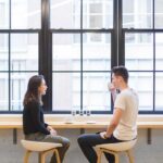 A man and a woman sitting drinking coffee