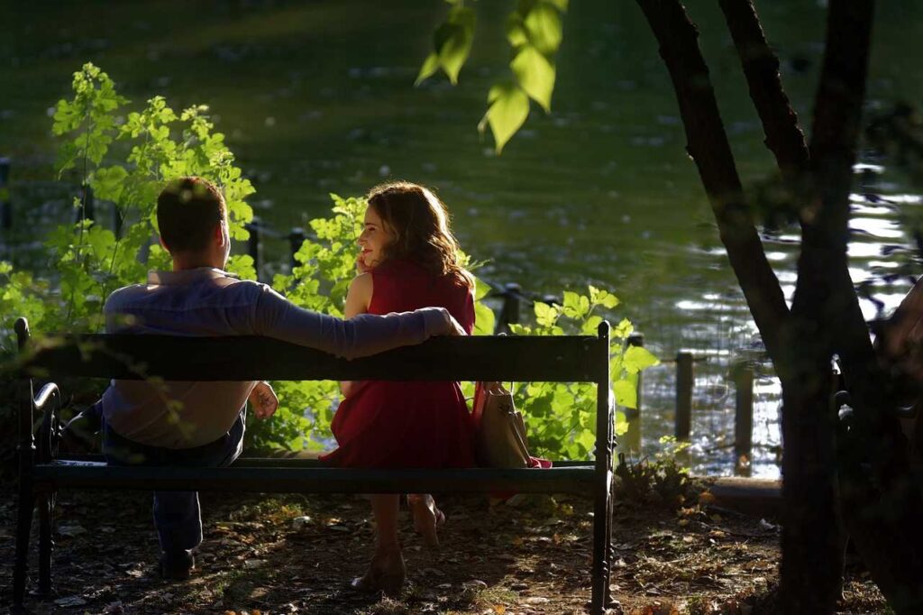 A man and a woman sitting in front of a late talking 