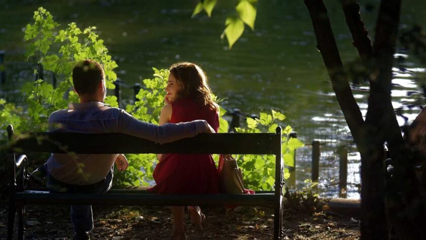 A man and a woman sitting in front of a late talking