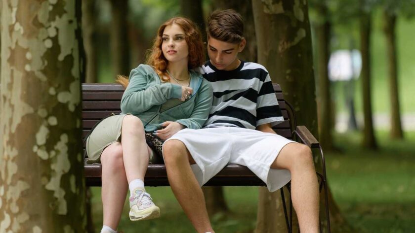 A woman and a man hanging out at the park