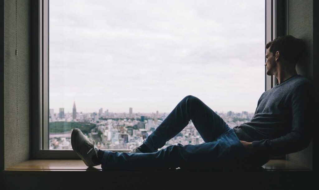 A man sitting on the window 