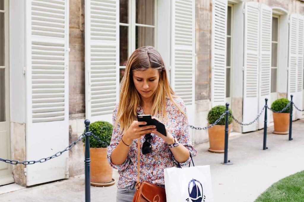 A woman texting while walking 