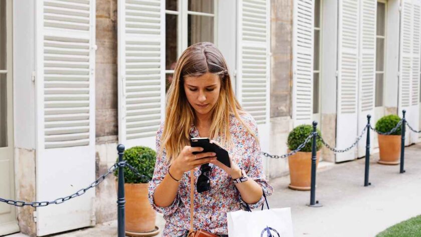 A woman texting while walking