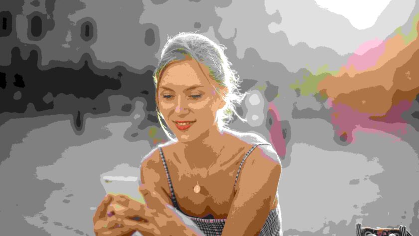 Woman texting while smiling