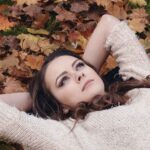 A woman laying on the ground looking up