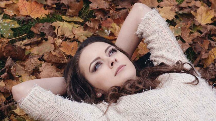 A woman laying on the ground looking up