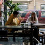 a man and a woman sitting in a coffee shop