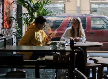 a man and a woman sitting in a coffee shop