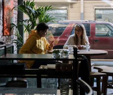 a man and a woman sitting in a coffee shop