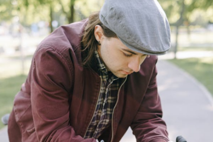 man reading a text while on a bycicle