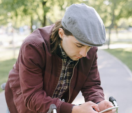 man reading a text while on a bycicle