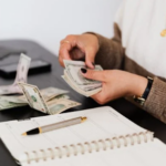 woman counting money on the table