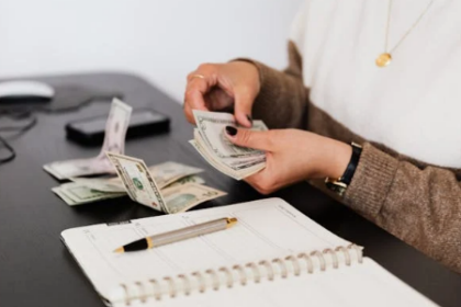 woman counting money on the table