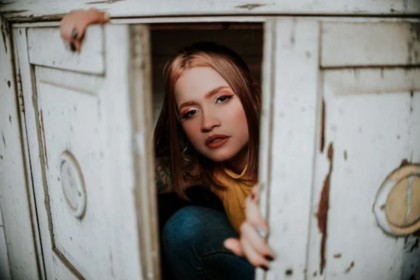 a woman hiding a closet