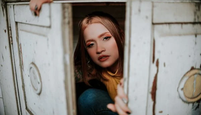 a woman hiding a closet