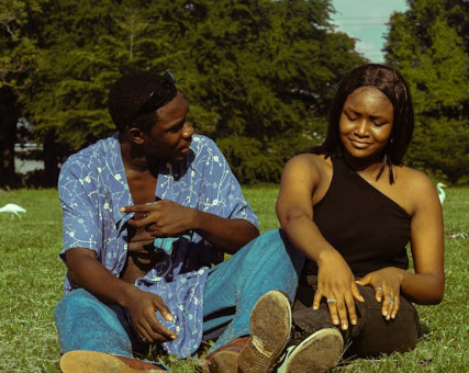 a woman and a man hanging out in a park