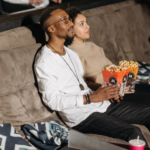 a man and a woman watching a movie in a cinema