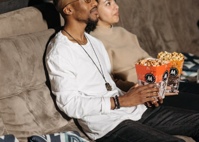 a man and a woman watching a movie in a cinema