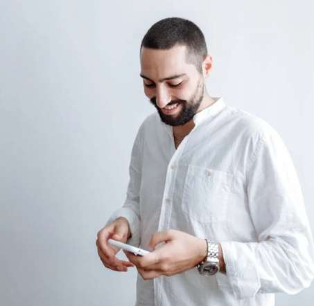 a man texting while smiling